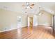 Large primary bedroom with hardwood floors, vaulted ceilings, 2 ceiling fans, and bright windows at 2359 Saint Kennedy Ln, Buford, GA 30518