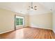 Spacious primary bedroom with vaulted ceiling, hardwood floors, and bright window at 2359 Saint Kennedy Ln, Buford, GA 30518