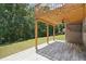 Covered patio with fan, lighting and wood-look tile overlooks backyard at 2359 Saint Kennedy Ln, Buford, GA 30518