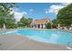 Community pool with ample seating and umbrellas, perfect for relaxing on a sunny day at 2359 Saint Kennedy Ln, Buford, GA 30518