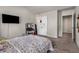 Bedroom with neutral tones, a TV, and closet doors, creating a serene and organized space at 2829 Wild Laurel Ct, Norcross, GA 30071