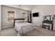 Bright bedroom with dual windows, showcasing a vanity and TV for comfort and convenience at 2829 Wild Laurel Ct, Norcross, GA 30071