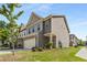 Charming townhome featuring a two-car garage, lush landscaping, and craftsman-style details at 2829 Wild Laurel Ct, Norcross, GA 30071