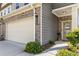 Charming entryway showcasing a two-car garage and a warm welcome sign at 2829 Wild Laurel Ct, Norcross, GA 30071