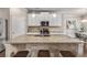Large kitchen island featuring a granite countertop, seating for three, and pendant lighting at 2829 Wild Laurel Ct, Norcross, GA 30071
