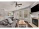 Open floor plan living room with fireplace, ceiling fan, hardwood floors and lots of light at 2829 Wild Laurel Ct, Norcross, GA 30071