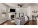 Cozy living room with fireplace, large window, ceiling fan, and hardwood floors at 2829 Wild Laurel Ct, Norcross, GA 30071