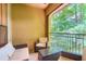This balcony features a seating area, metal railing, and view of trees at 3777 Peachtree Ne Rd # 438, Brookhaven, GA 30319
