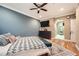 A well-lit bedroom features hardwood floors, a flat screen tv, and an ensuite bath behind an archway at 3777 Peachtree Ne Rd # 438, Brookhaven, GA 30319