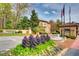 Inviting community entrance with mature landscaping, flags, and a decorative water fountain feature at 3777 Peachtree Ne Rd # 438, Brookhaven, GA 30319