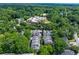 Aerial view of townhomes surrounded by lush green trees and buildings in the background at 1325 Oakview Rd, Decatur, GA 30030