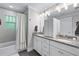 Elegant bathroom with granite countertops, a shower-tub, and modern light fixtures at 1325 Oakview Rd, Decatur, GA 30030