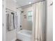 Well-lit bathroom with a shower-tub, towel rack, and linen curtain at 1325 Oakview Rd, Decatur, GA 30030