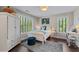 Bright bedroom featuring a bed, windows with views, and a study desk at 1325 Oakview Rd, Decatur, GA 30030