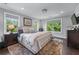 Comfortable bedroom with large windows offering green views, hardwood floors, and cozy rug at 1325 Oakview Rd, Decatur, GA 30030
