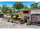 Charming storefront featuring an outdoor patio with yellow umbrellas and artistic mural on the exterior wall at 1325 Oakview Rd, Decatur, GA 30030