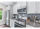 Modern kitchen featuring stainless steel appliances, granite countertops, and ample cabinet space at 1325 Oakview Rd, Decatur, GA 30030