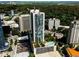 Aerial view of high-rise building with a rooftop pool and parking deck in a lush neighborhood at 3324 Peachtree Ne Rd # 2718, Atlanta, GA 30326
