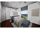 Relaxing bedroom with hardwood floors, neutral tones, and a large window with cityscape views at 3324 Peachtree Ne Rd # 2718, Atlanta, GA 30326