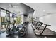 Modern gym with treadmills, elliptical machines, and large windows overlooking the city at 3324 Peachtree Ne Rd # 2718, Atlanta, GA 30326