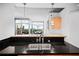 Granite countertops highlight this kitchen with a stainless sink and a view of the city beyond at 3324 Peachtree Ne Rd # 2718, Atlanta, GA 30326