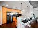 Modern kitchen with stainless steel appliances, black backsplash, light wood cabinets and bar seating at 3324 Peachtree Ne Rd # 2718, Atlanta, GA 30326