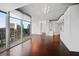 Bright living room featuring floor-to-ceiling windows showcasing a city view, and hardwood floors at 3324 Peachtree Ne Rd # 2718, Atlanta, GA 30326