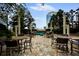 Outdoor seating area with tables and chairs surrounded by lush greenery and skyline views at 3324 Peachtree Ne Rd # 2718, Atlanta, GA 30326