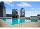 Rooftop swimming pool with lounge chairs overlooking the city skyline at 3324 Peachtree Ne Rd # 2718, Atlanta, GA 30326