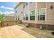 Spacious wooden back deck with brick trim, perfect for outdoor entertaining at 5515 Cheatam Ave, Cumming, GA 30040