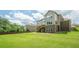 Expansive backyard with a lush lawn, fenced perimeter, backing up to mature trees, providing a private outdoor space at 5515 Cheatam Ave, Cumming, GA 30040