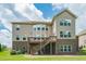 Lovely backyard view showcases a large deck with stairs and brick-base exterior, and well manicured green grass at 5515 Cheatam Ave, Cumming, GA 30040