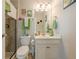 Well-lit bathroom featuring a toilet, sink, vanity, and a shower at 5515 Cheatam Ave, Cumming, GA 30040