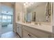 Bright bathroom with double sink vanity, ample counter space, and a connecting bedroom at 5515 Cheatam Ave, Cumming, GA 30040