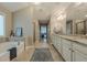Bright bathroom featuring a soaking tub, walk-in shower, double vanity, and tile floors at 5515 Cheatam Ave, Cumming, GA 30040
