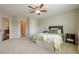 Cozy bedroom with carpet flooring, ceiling fan, and a view into another room at 5515 Cheatam Ave, Cumming, GA 30040