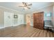 Bedroom with hardwood floors, neutral walls, and ceiling fan and cabinet at 5515 Cheatam Ave, Cumming, GA 30040
