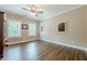 Bright bedroom features hardwood floors, neutral walls, and ceiling fan at 5515 Cheatam Ave, Cumming, GA 30040