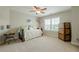 This neutral bedroom features a charming daybed, a ceiling fan, and a dresser cabinet at 5515 Cheatam Ave, Cumming, GA 30040