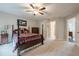Spacious bedroom with a four poster bed, ceiling fan, and ensuite bathroom at 5515 Cheatam Ave, Cumming, GA 30040