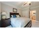 Bedroom with plush carpeting, a comfortable bed, and a view into a bathroom at 5515 Cheatam Ave, Cumming, GA 30040