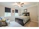 Cozy bedroom with plush carpeting, a comfortable bed, and two windows providing natural light at 5515 Cheatam Ave, Cumming, GA 30040