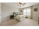 Well-lit bedroom with ceiling fan, window with blinds, and floral patterned bedding at 5515 Cheatam Ave, Cumming, GA 30040