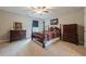Traditional bedroom with a four poster bed, ceiling fan, and coordinating furniture at 5515 Cheatam Ave, Cumming, GA 30040