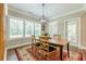 Cozy dining room filled with natural light from large windows, features a wooden table at 5515 Cheatam Ave, Cumming, GA 30040