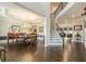 Elegant dining room with a chandelier, hardwood floors, and an open floor plan at 5515 Cheatam Ave, Cumming, GA 30040