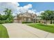 Beautiful two-story brick home with a three car garage, long driveway and manicured lawn at 5515 Cheatam Ave, Cumming, GA 30040