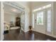 Inviting foyer with hardwood floors, a glass-paned front door, and natural light at 5515 Cheatam Ave, Cumming, GA 30040