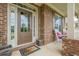 Close-up of the front entrance, featuring a stylish front door and a welcoming front porch at 5515 Cheatam Ave, Cumming, GA 30040