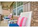Cozy front porch with rocking chairs, cushions, and a view of the well-maintained lawn at 5515 Cheatam Ave, Cumming, GA 30040